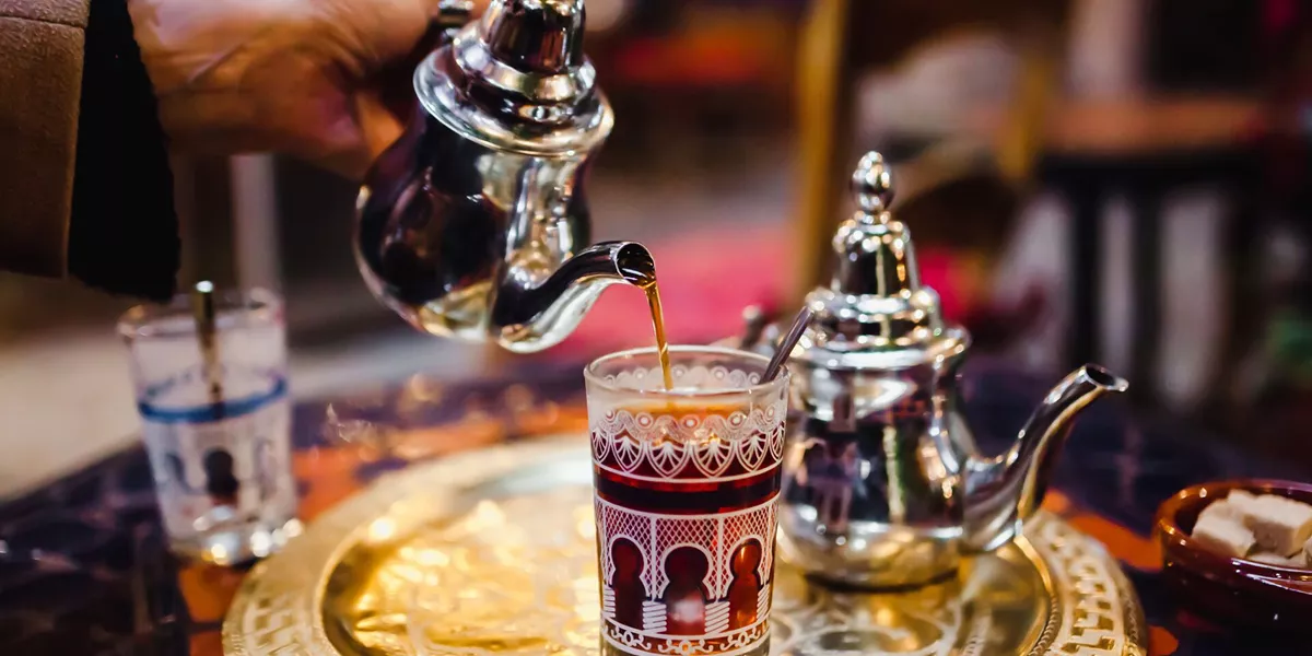 Berber pouring traditional arabic tea