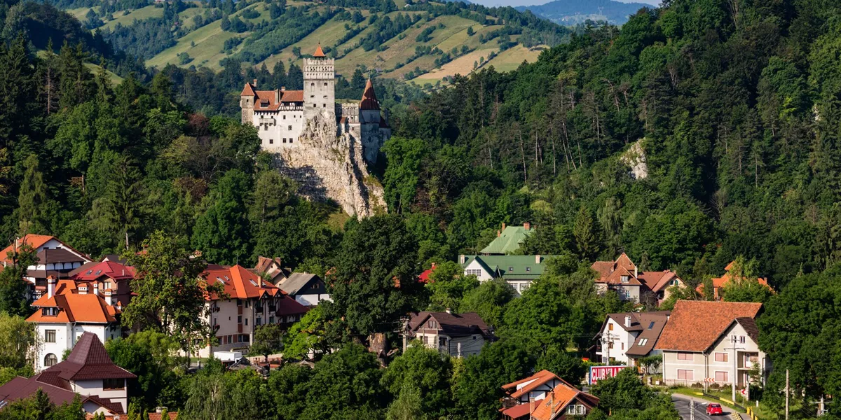Houses and castle in valley, Bran, Transylvania, Romania