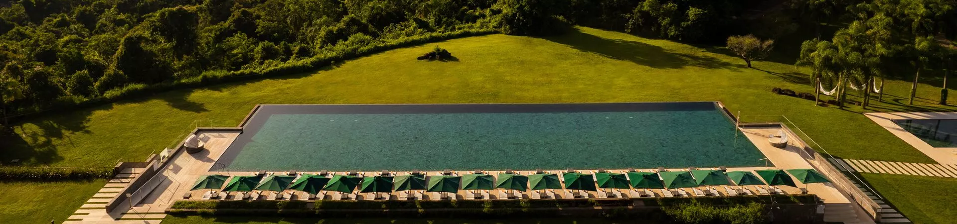 A swimming pool with the Iguazzu Falls in the background