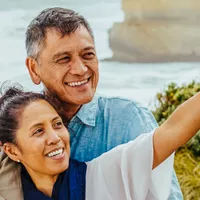 A group of tourists taking a selfie on a beach.
