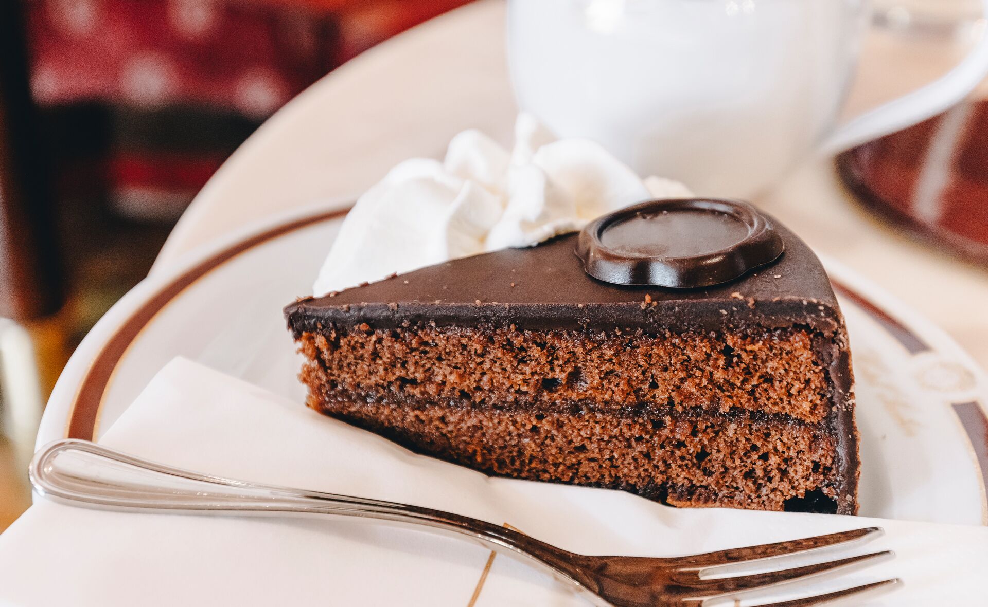 Traditional Austrian Sacher Torte Chocolate Cake Sliced On White Plate