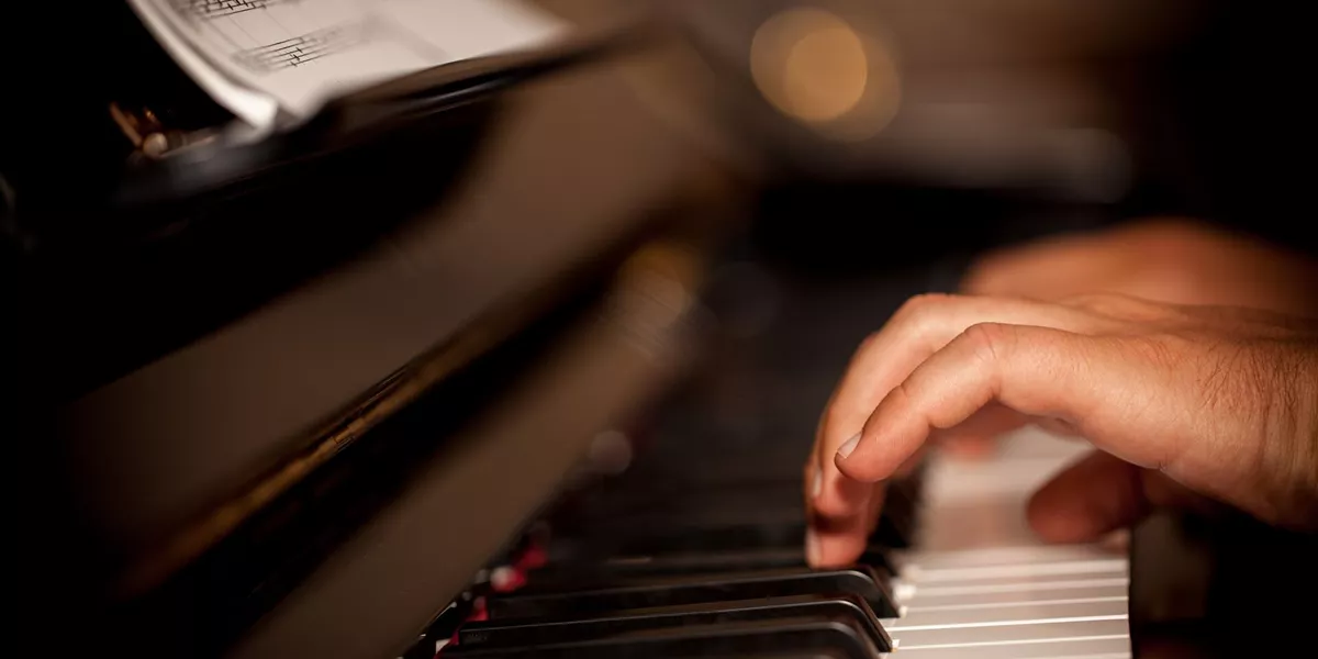 Large Person Playing Piano 1206253192