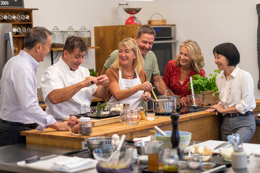 Guests enjoying a cooking demonstration