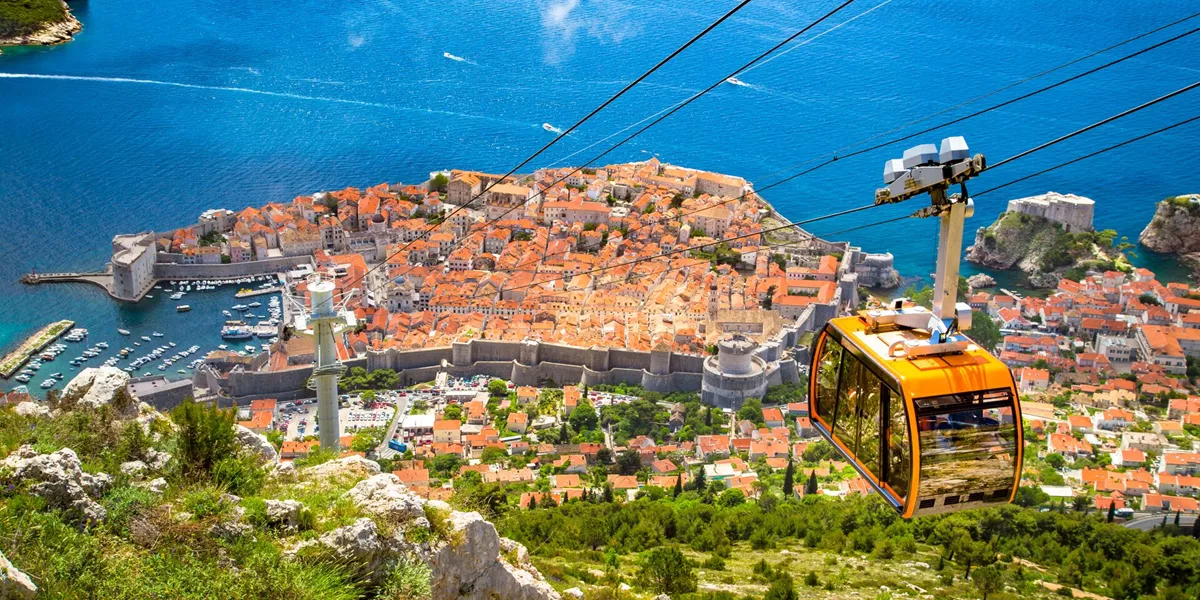 Old town off Dubrovnik with a cable car ascending Srd Mountain in Dalmatia, Croatia