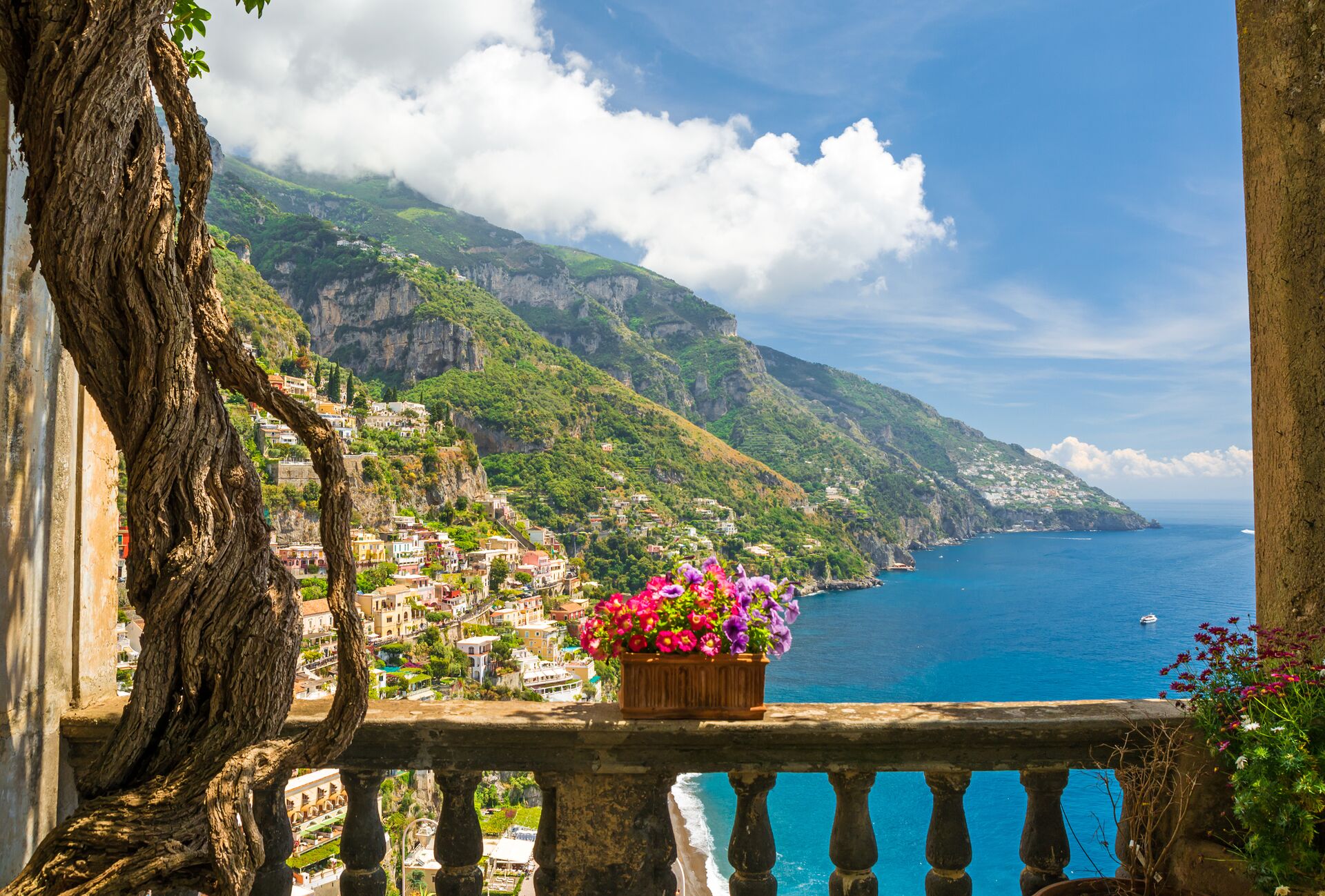 Beautiful view of the town of Positano from a terrace with flowers in the Amalfi coast, Italy