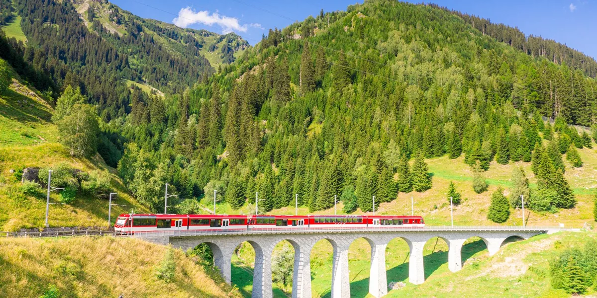 Glacier Express Train on the Tujetsch Viaduct on a sunny day in Switzerland