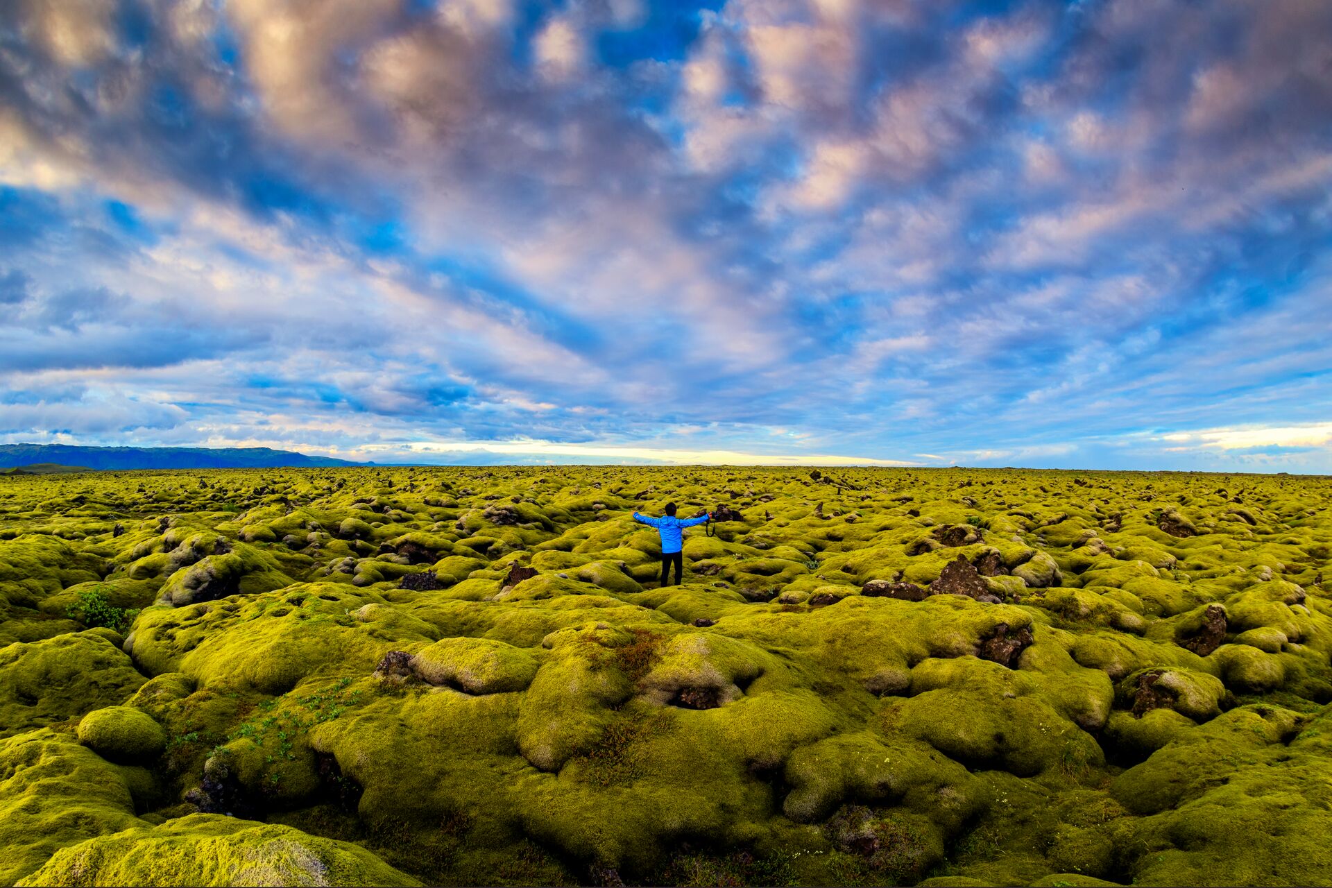 Solo traveller in a lava moss field in Iceland