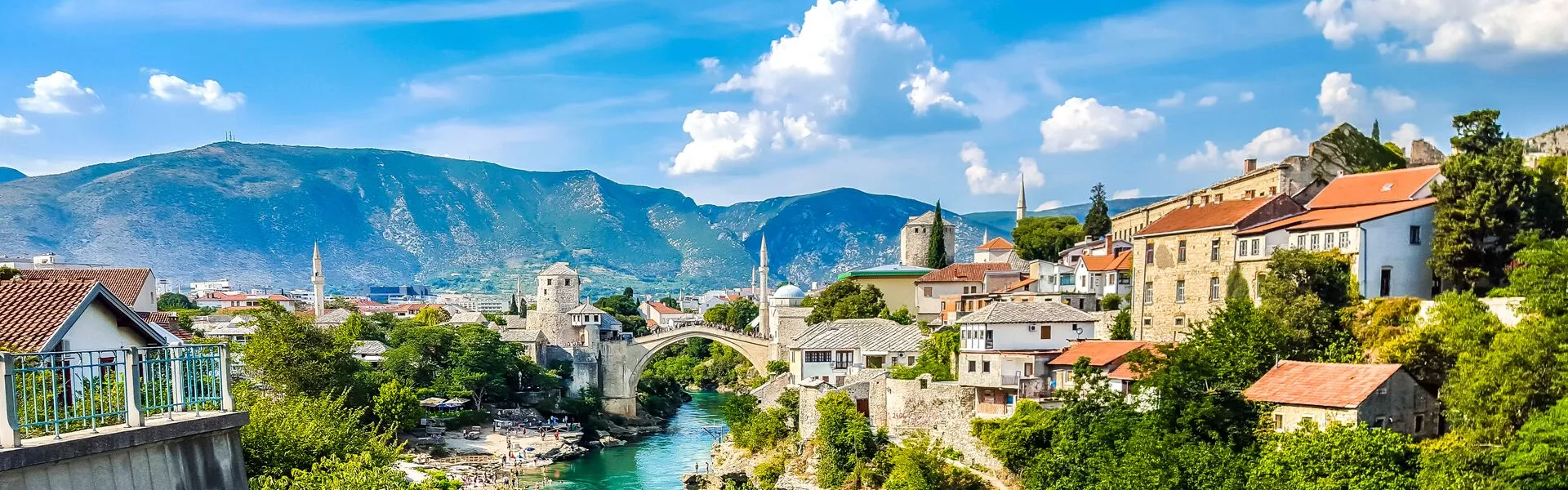 The old bridge in Mostar with mountains behind