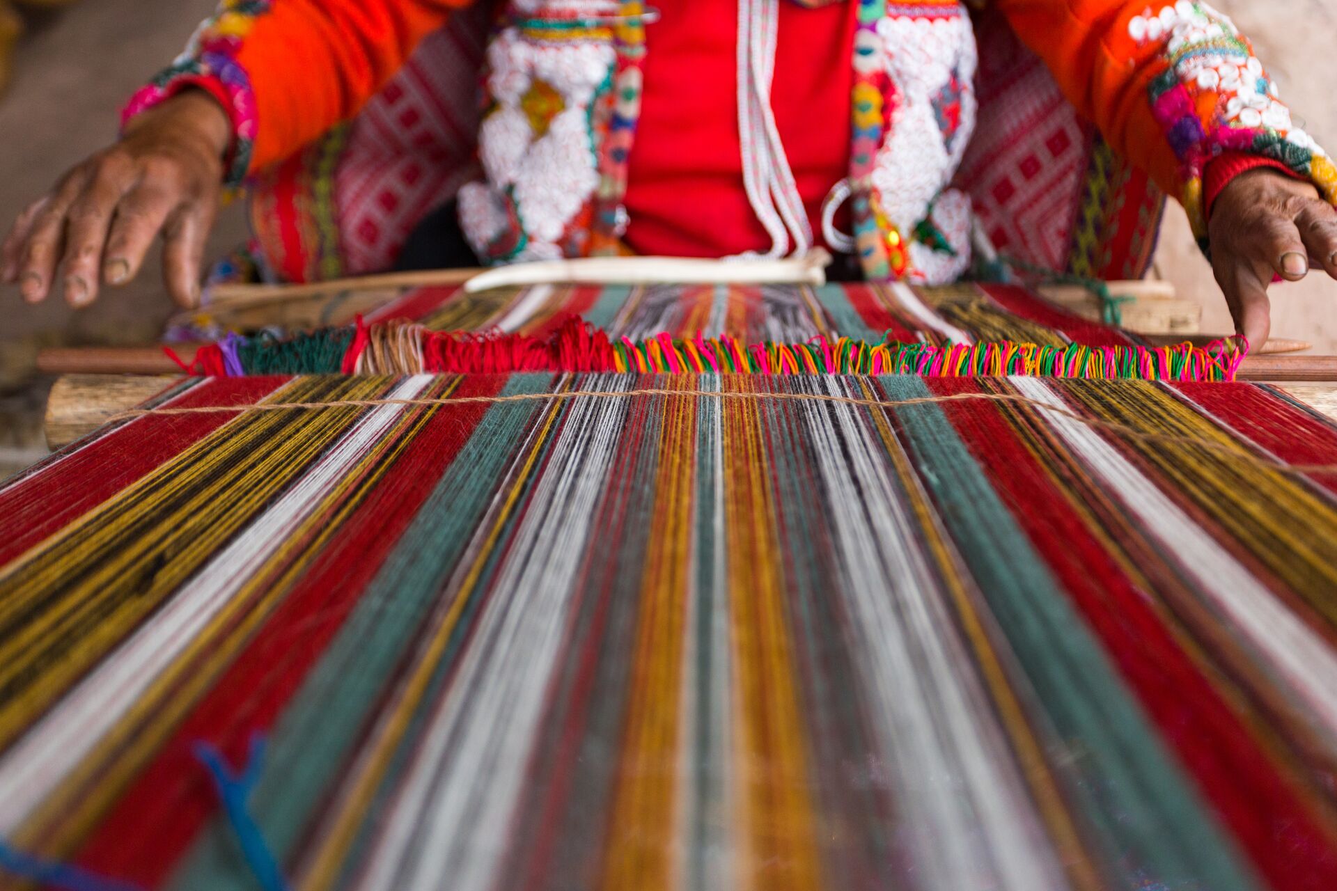 Close up of a woman weaving in Peru, South America