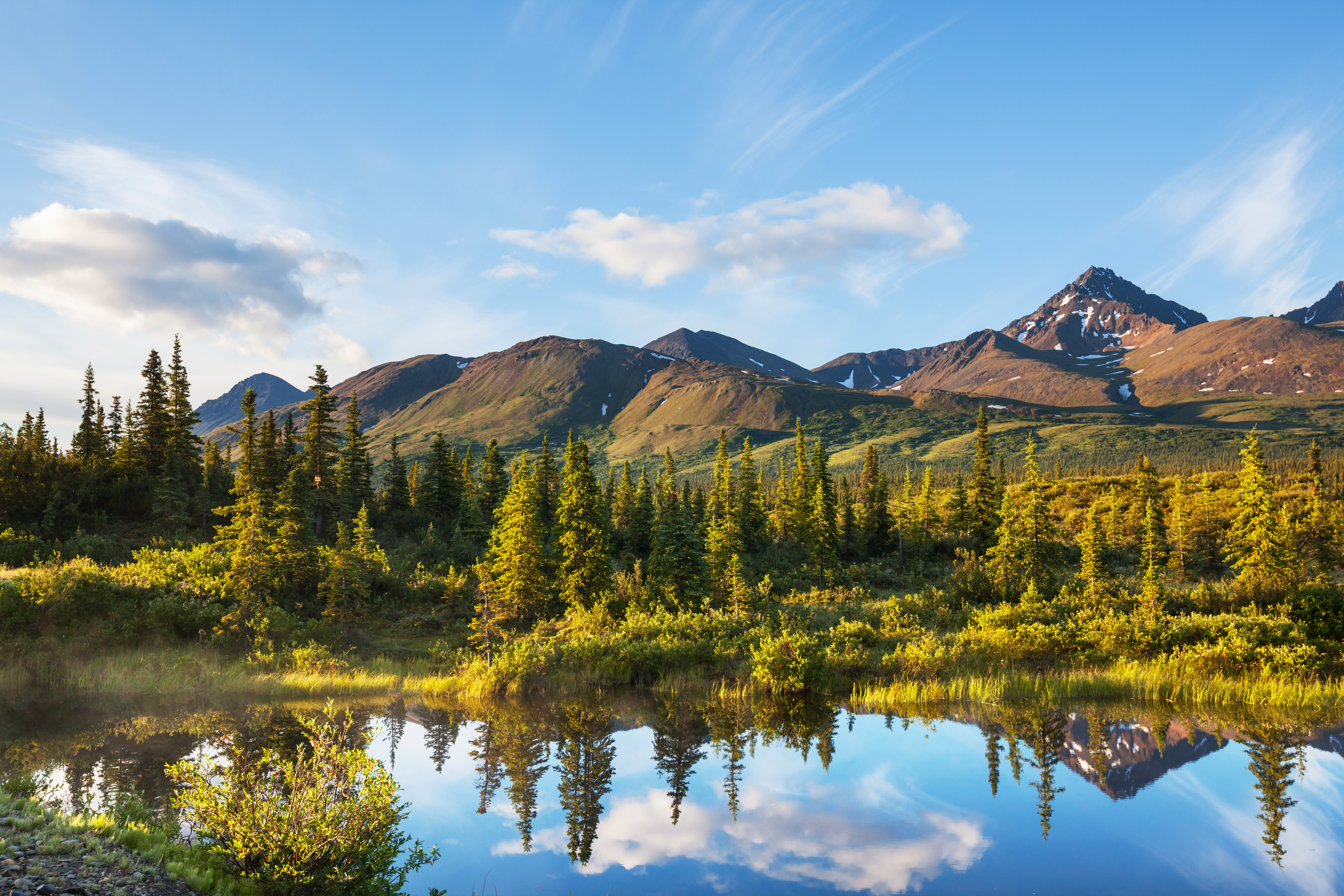 A mountain landscape and the sky reflected in the lake
