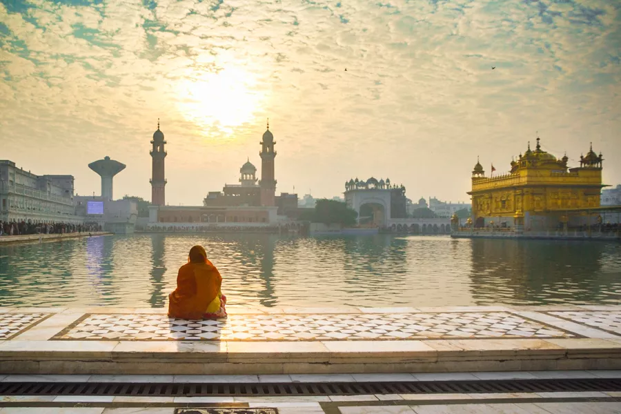 Woman Praying At Golden Temple, India