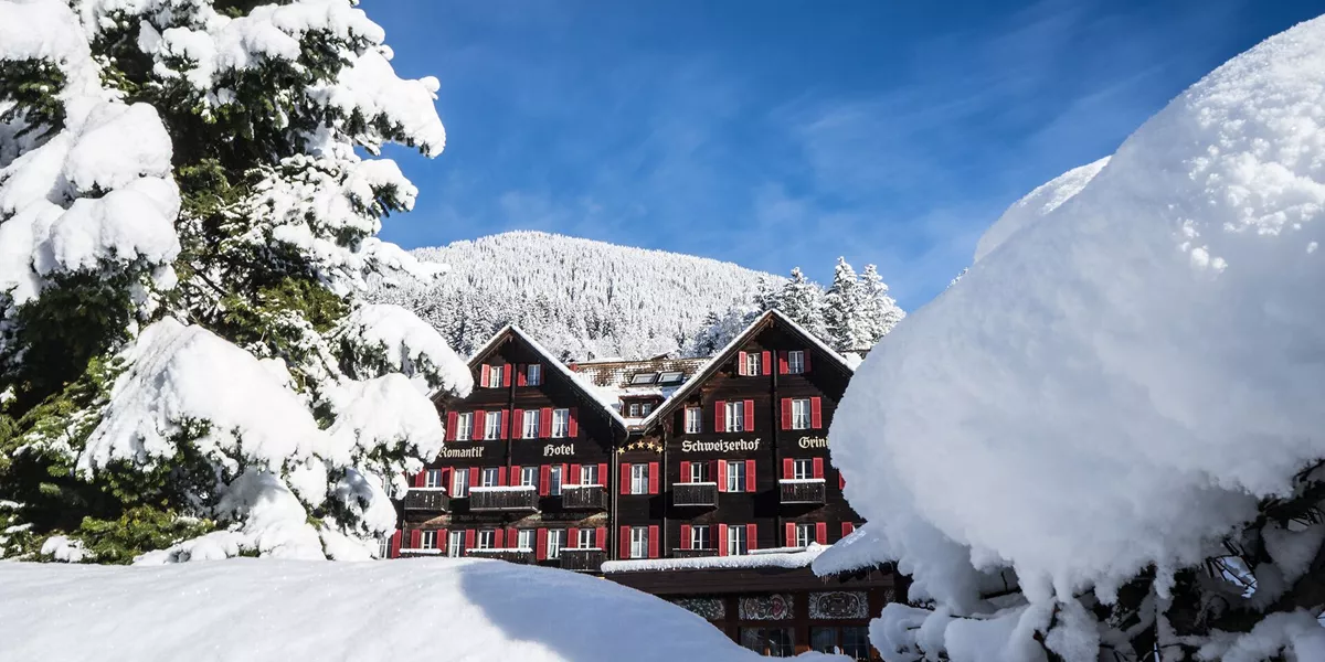 Schweizerhof Grindelwald Hotel covered in snow during winter in Switzerland