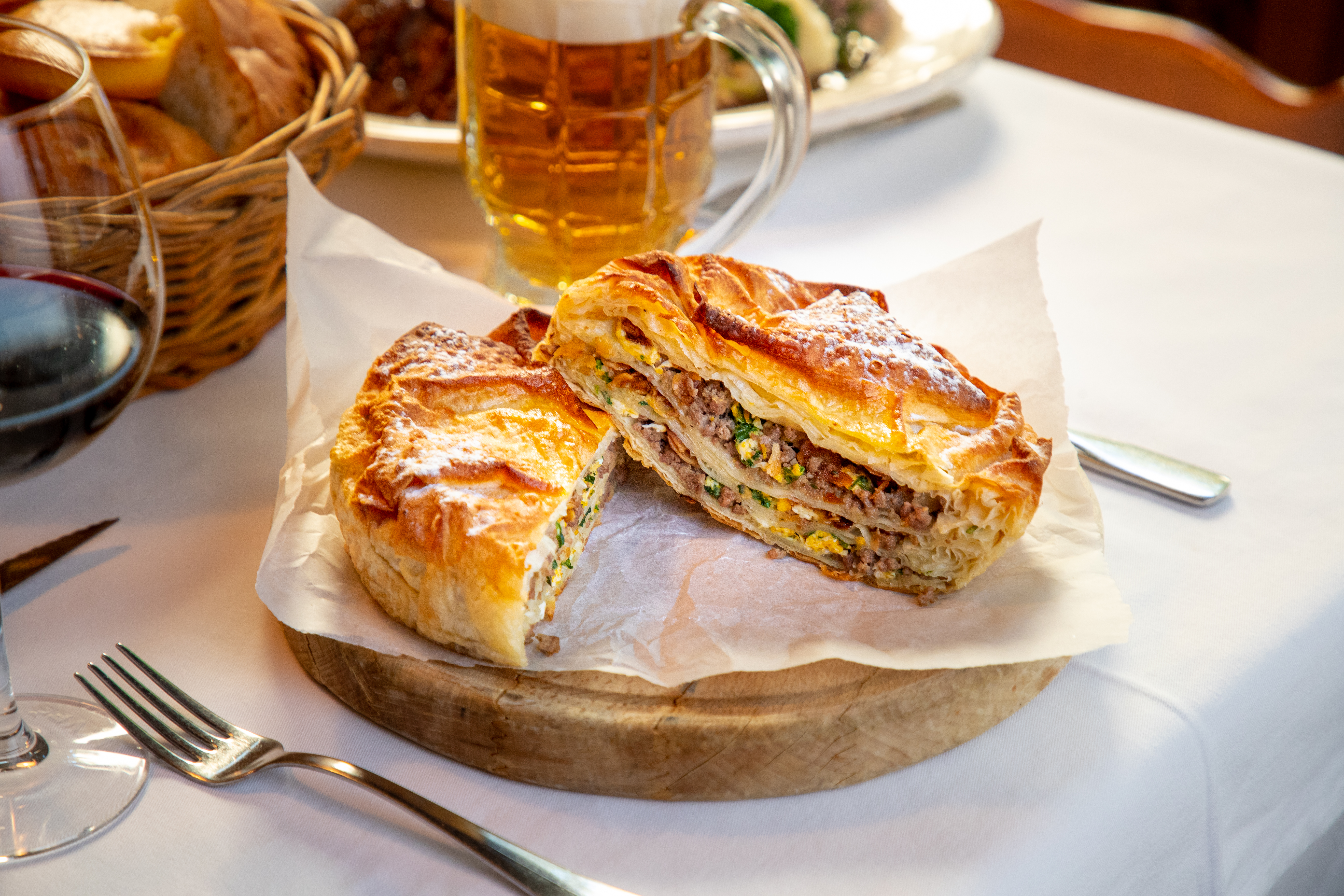 Burek With Minced Meat And Other Ingredients Cut In Half, Rustic Place Setting 1302977773