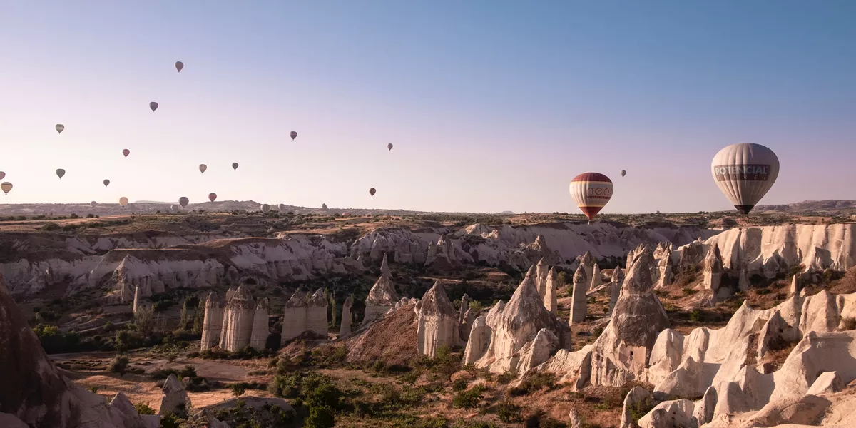 Balloons floating above the rocky valley in Cappadocia
