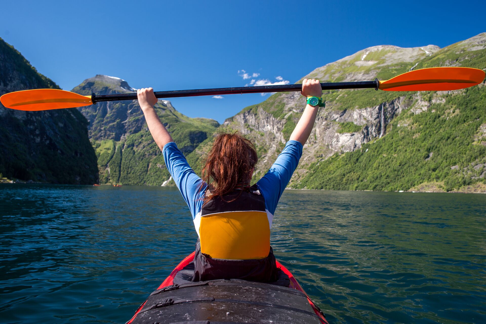 Girl Kayaking in a Norwegian Fjord in Scandinavia