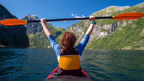 Girl Kayaking in a Norwegian Fjord in Scandinavia