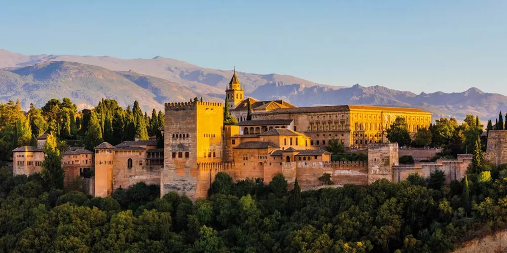 The Alhambra fortress and Sierra Nevada mountains at sunset, Granada, Spain