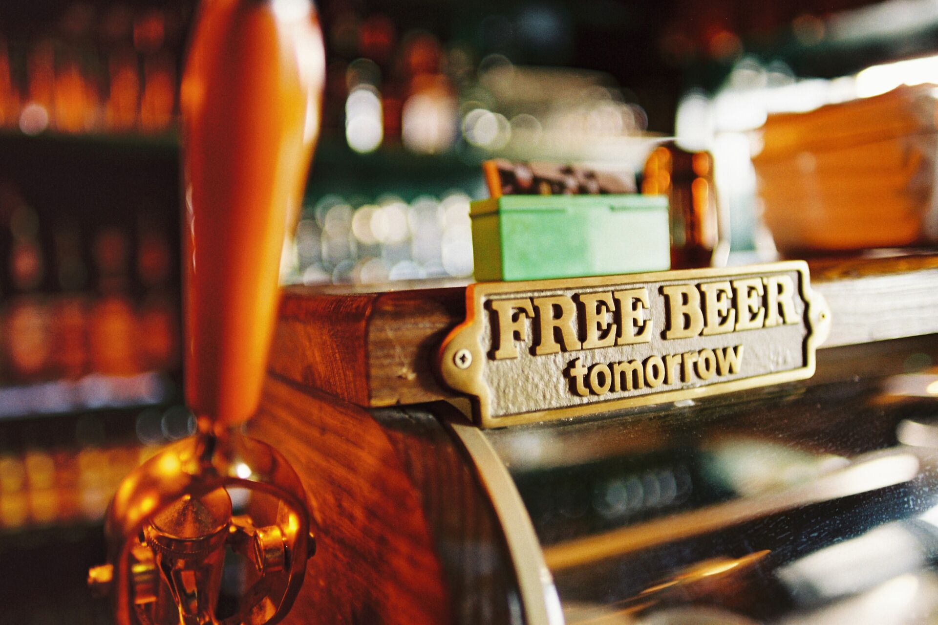Close up image of a metal sign in a pub saying 'Free Beer Tomorrow'