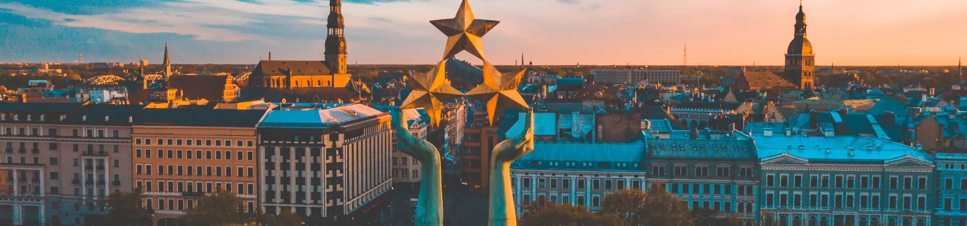 Sunset over Riga with the Statue of Liberty Milda in the foreground in Latvia, Eastern Europe