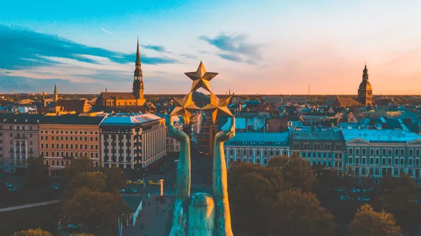 Sunset over Riga with the Statue of Liberty Milda in the foreground in Latvia, Eastern Europe