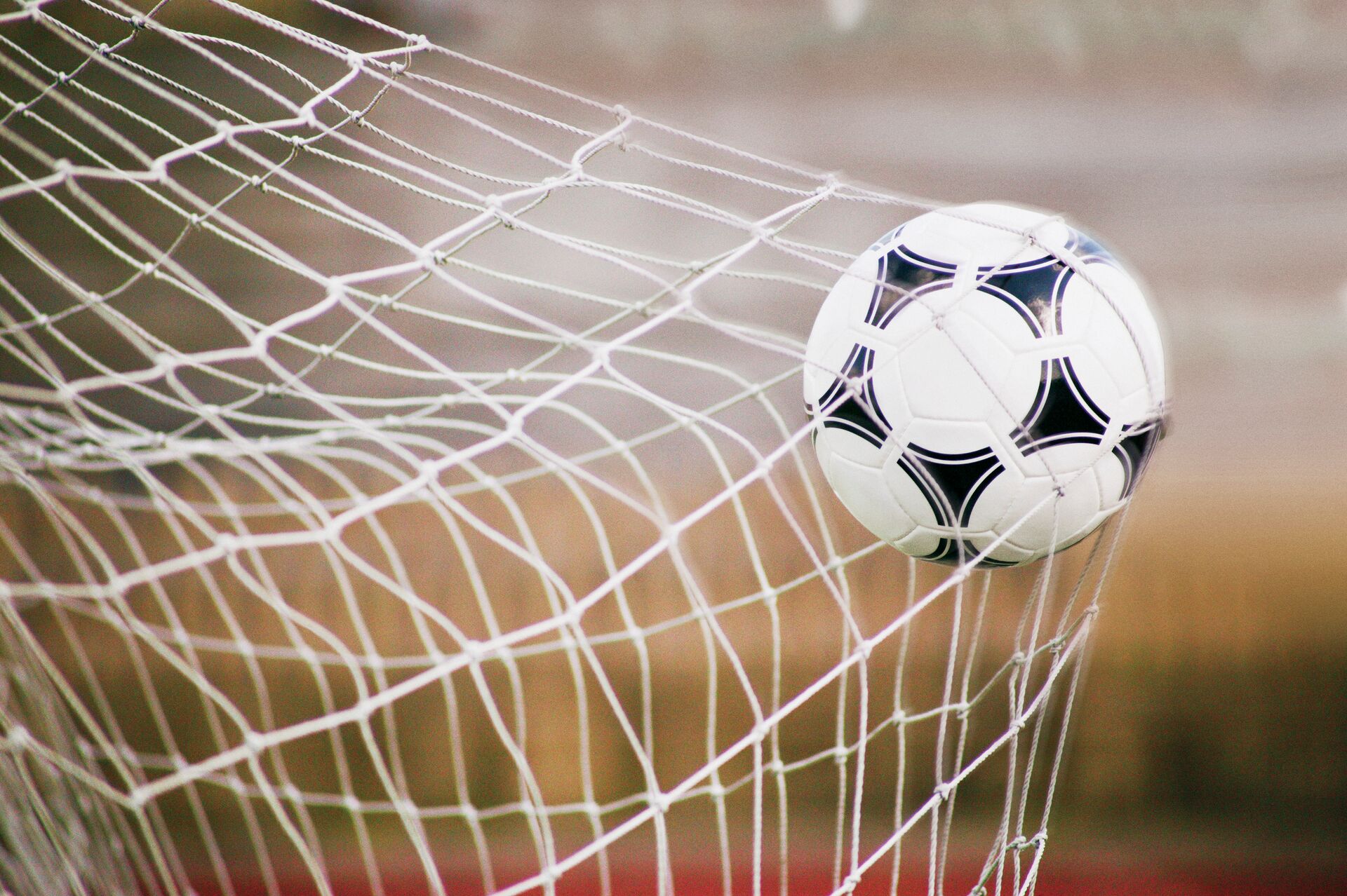 Close Up of a football trapped in a goal net