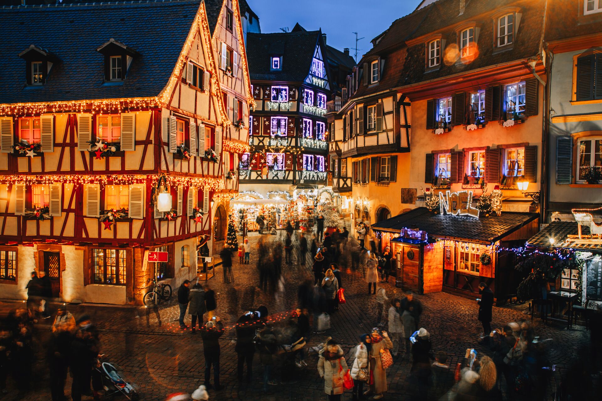 People in front of the traditional houses of Strasbourg during Christmas