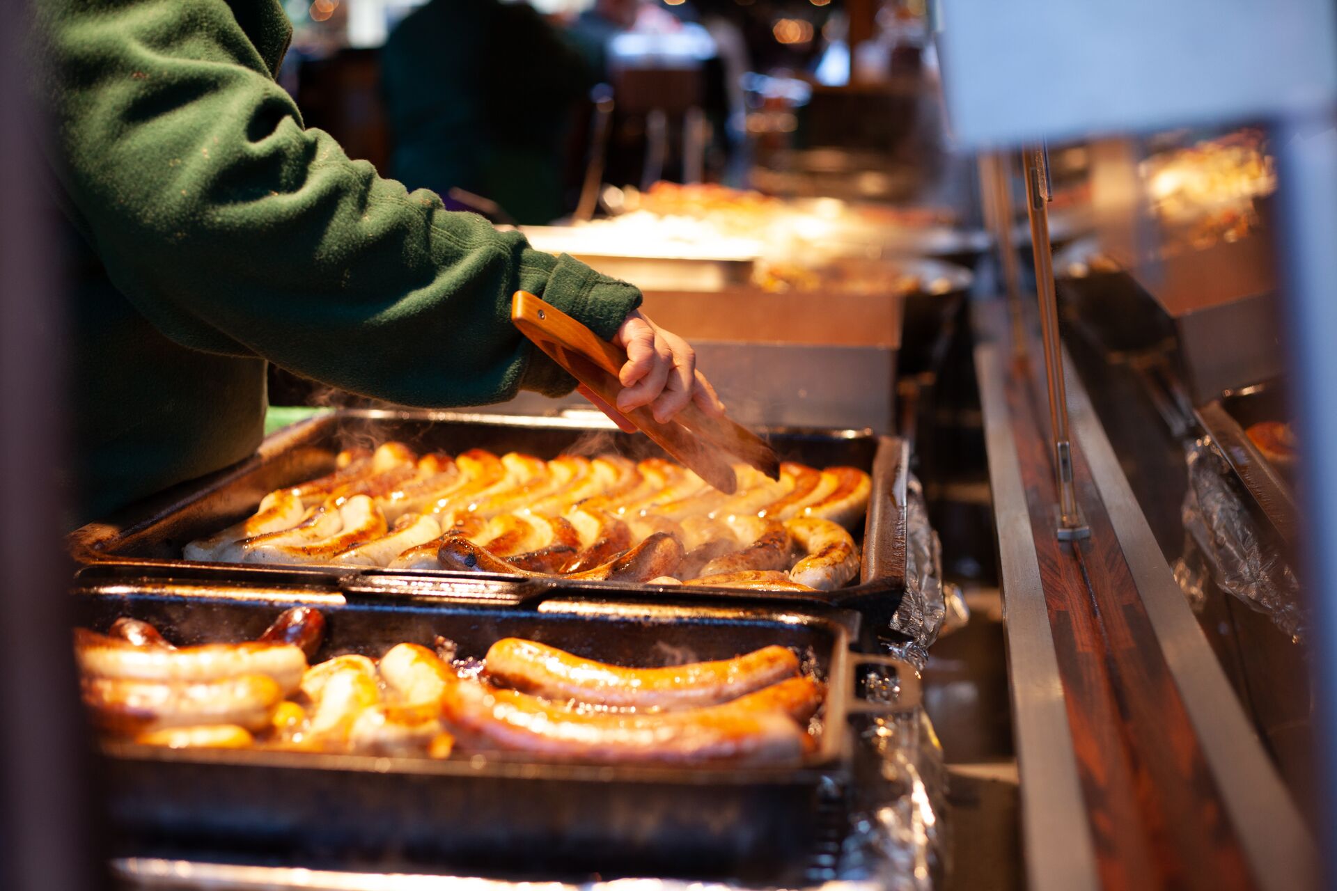 Sausages being fried at a food stall