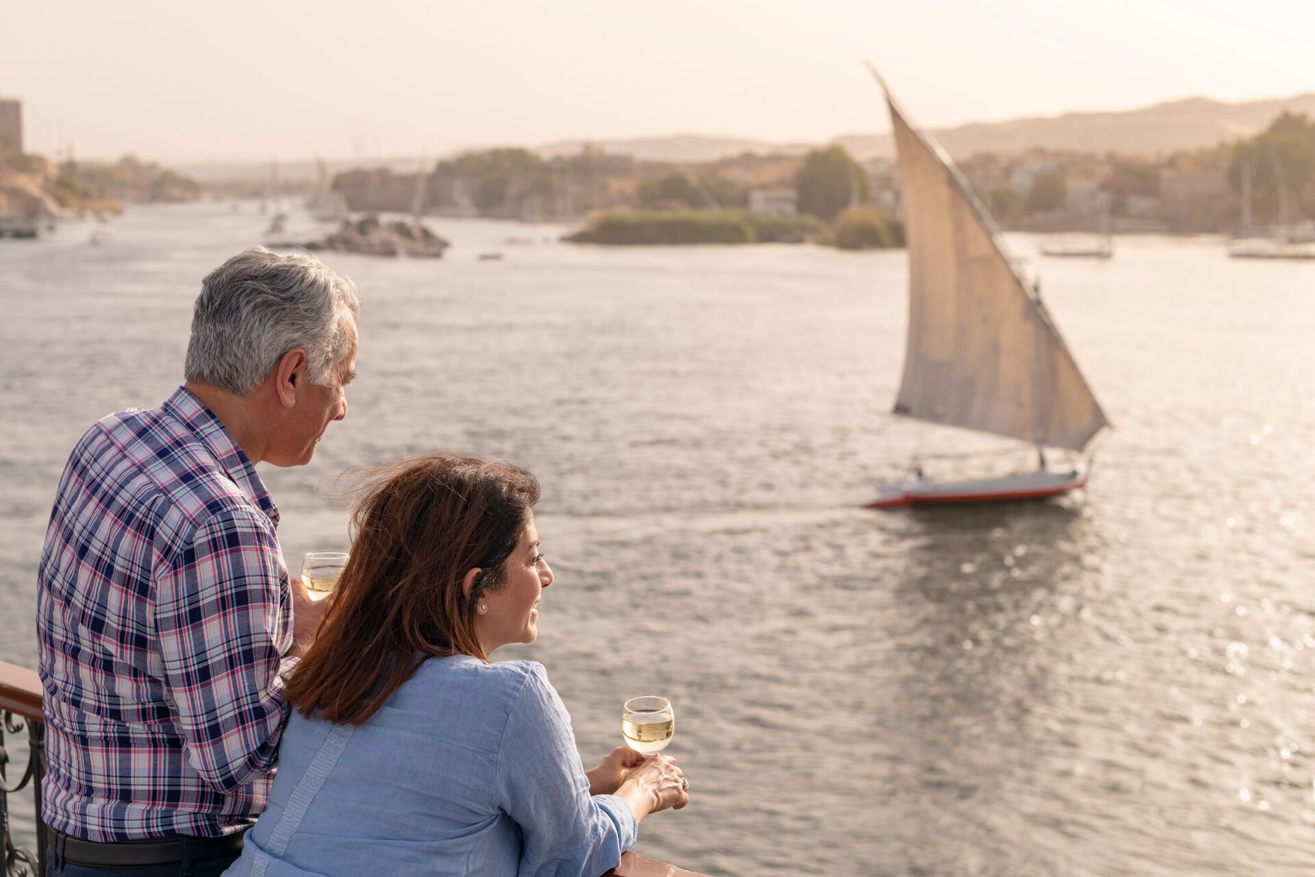 Couple watching boats sailing on the Nile in Egypt, Africa