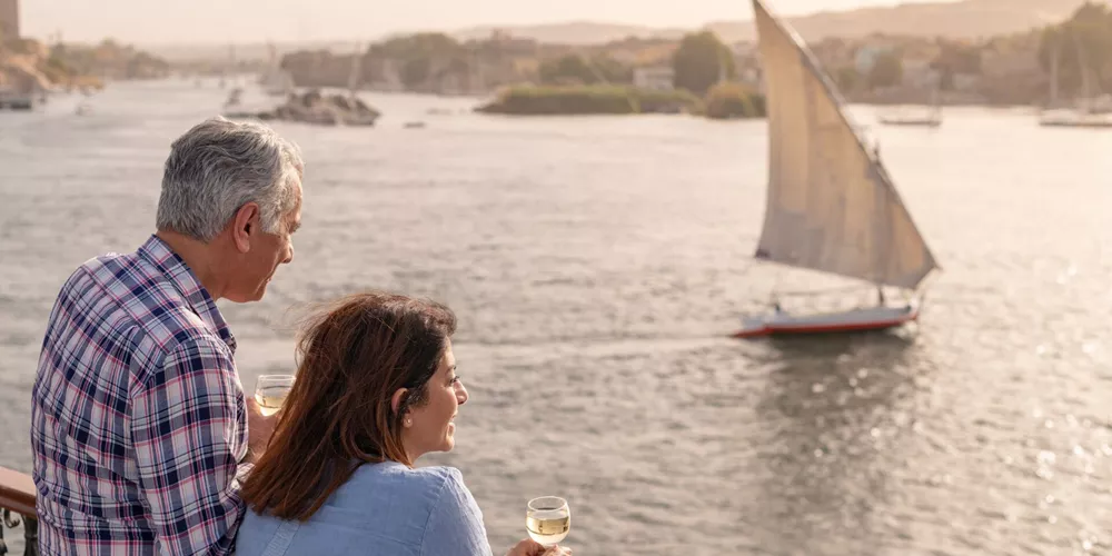 Couple watching boats sailing on the Nile in Egypt, Africa