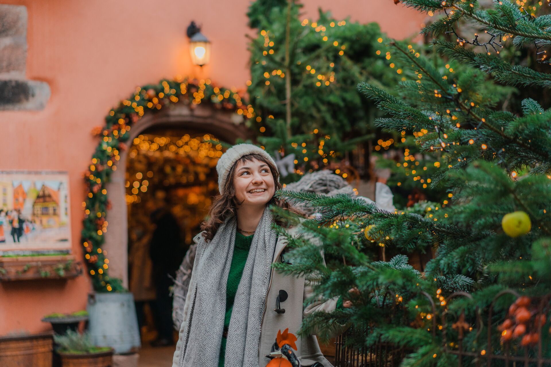 Woman looking at a Christmas Tree while visiting a Christmas Market in Europe