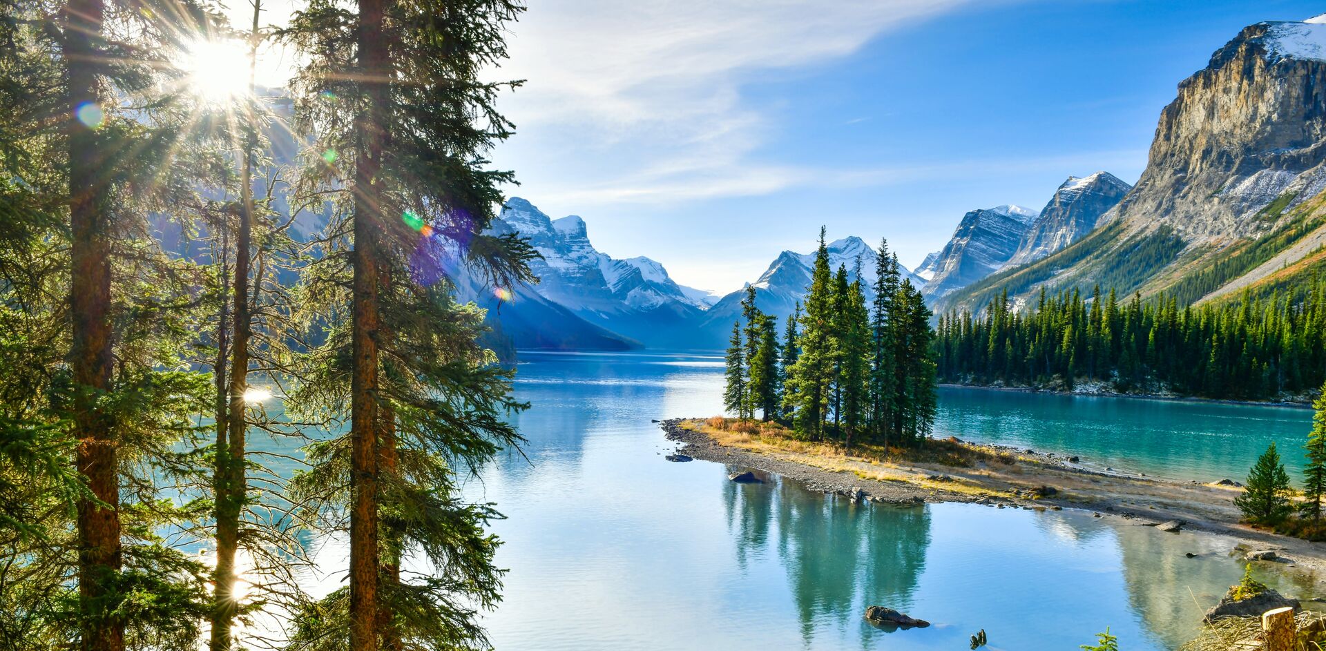 Sun peaking through the trees Spirit Island In Maligne Lake, Jasper National Park, Alberta, Canada