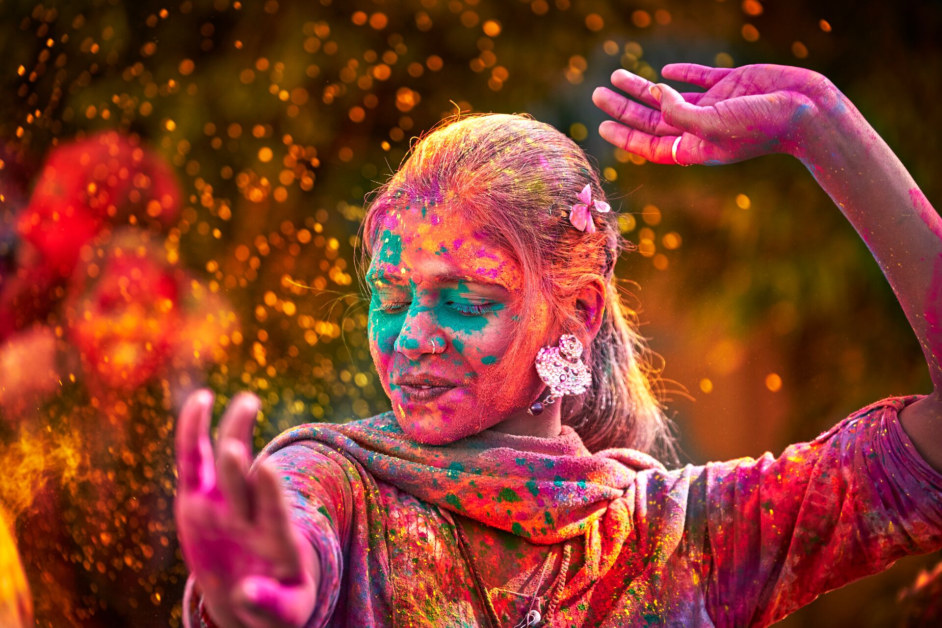 Indian Woman With Colored Face Dancing During Holi in India