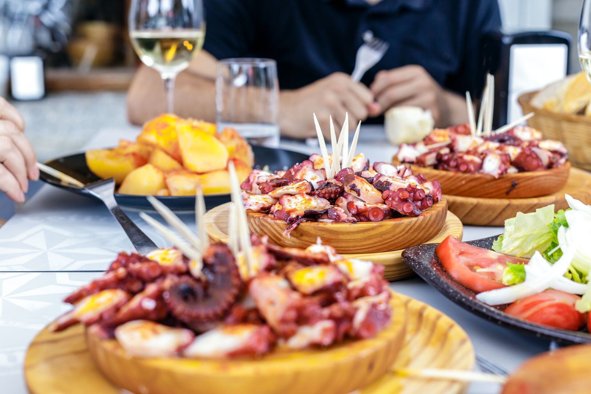 People Eating Pulpo a la Gallega in Galicia, Spain