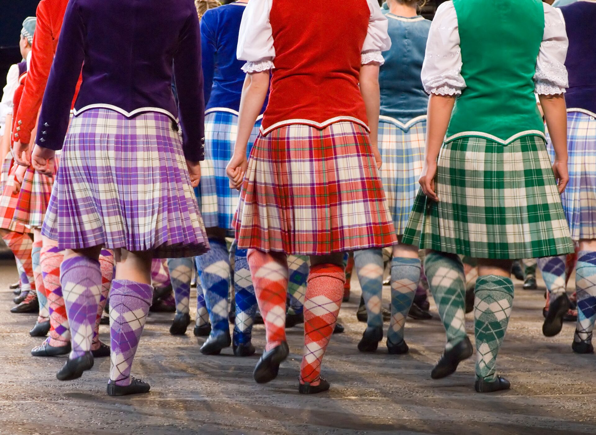 People in traditional tartans marching in Edinburgh, Scotland