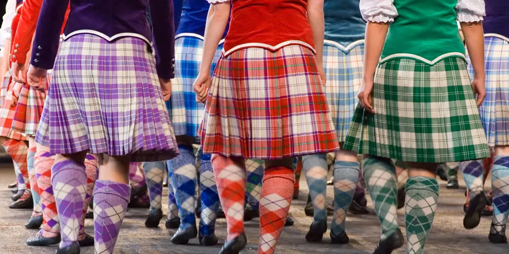 People in traditional tartans marching in Edinburgh, Scotland