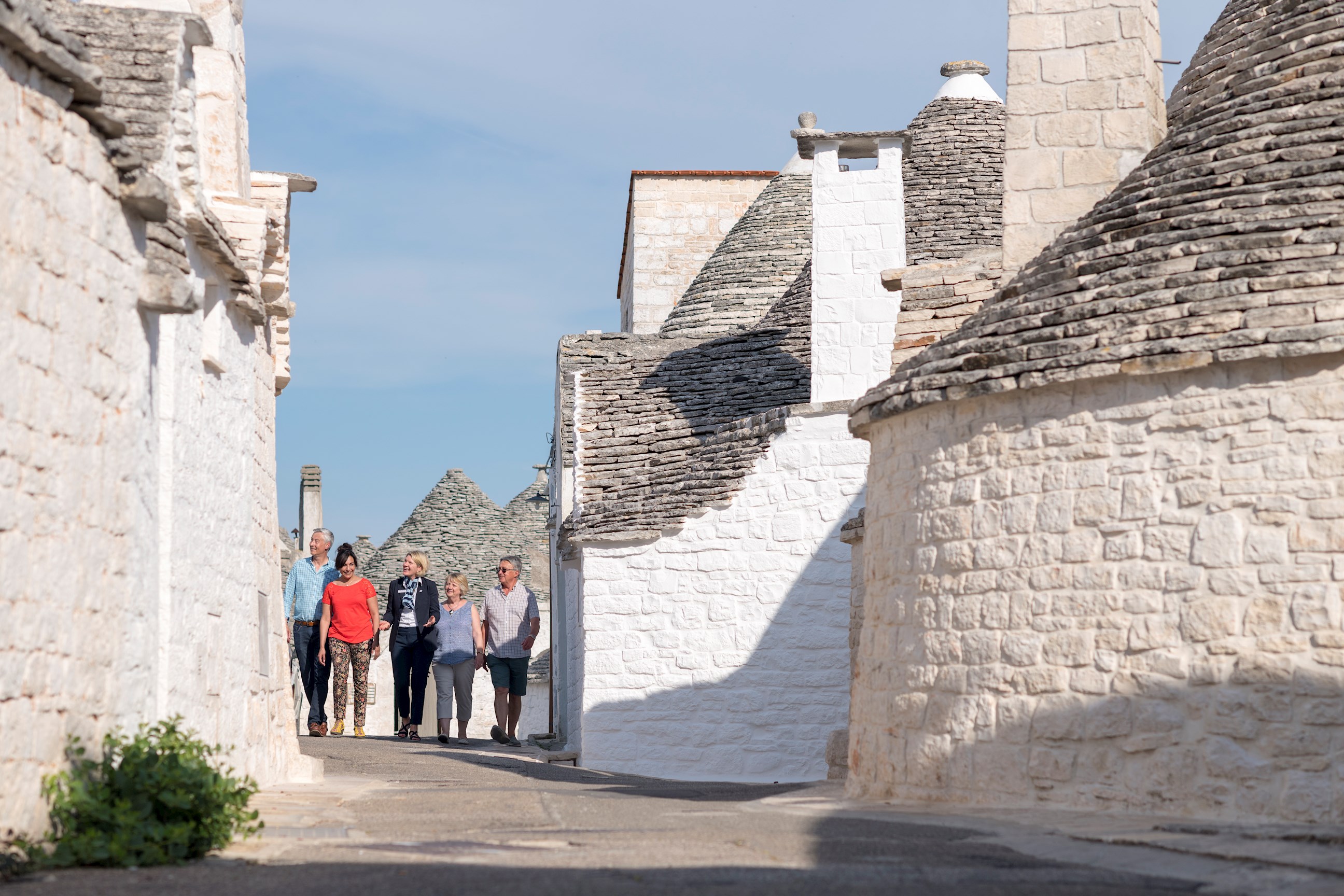 Tourists walking through Alberobello, Italy