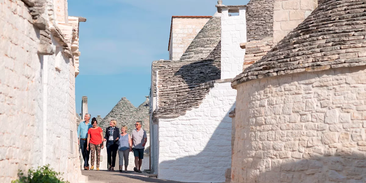 Tourists walking through Alberobello, Italy