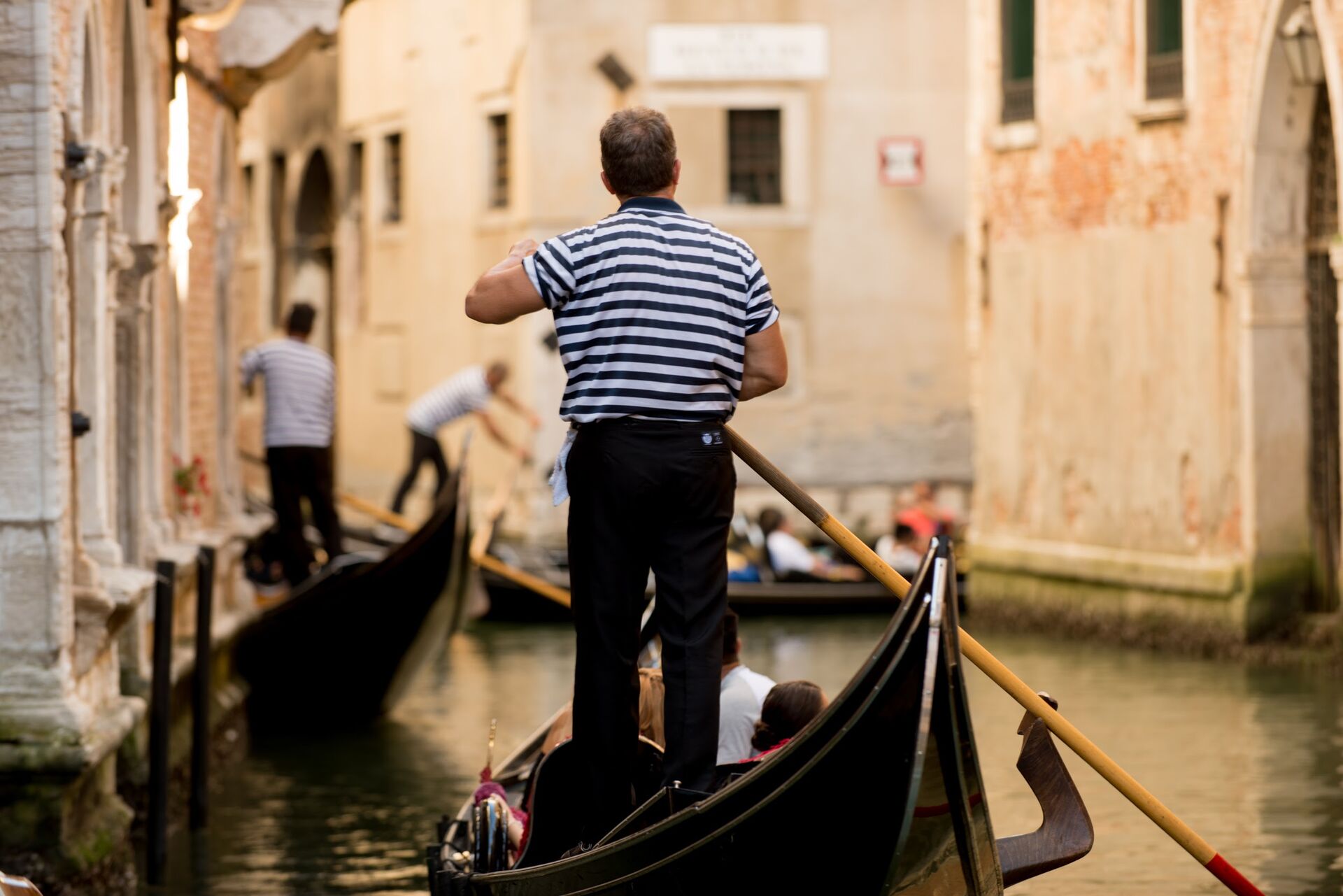 Gondoler driving a gondola in Venice, Italy