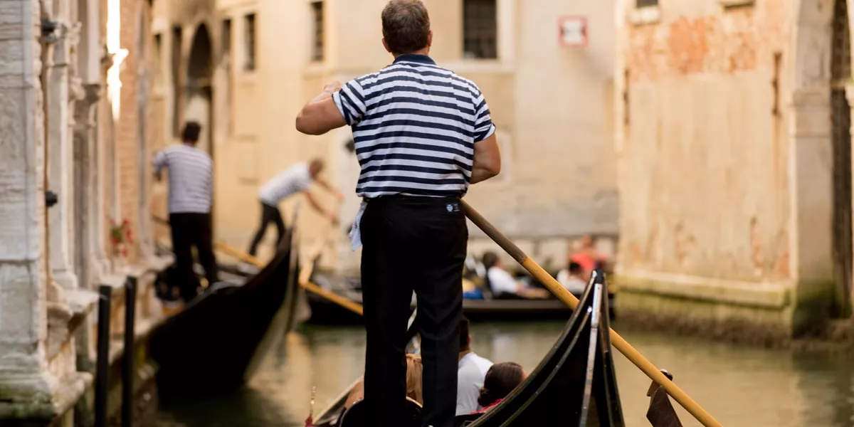 Gondoler driving a gondola in Venice, Italy