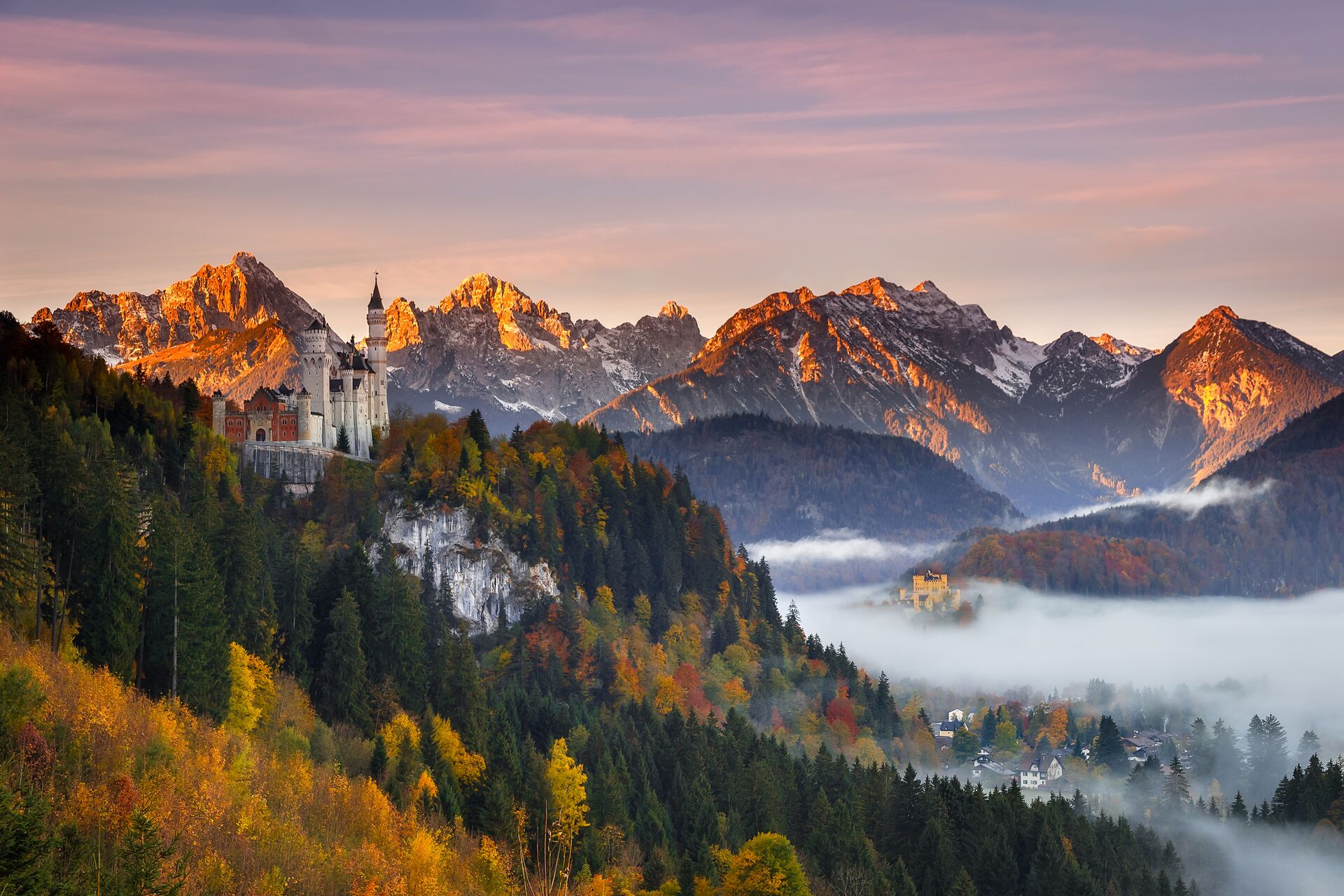 Neuschwanstein Castle in Bavaria, Germany surrounded by Autumn foliage