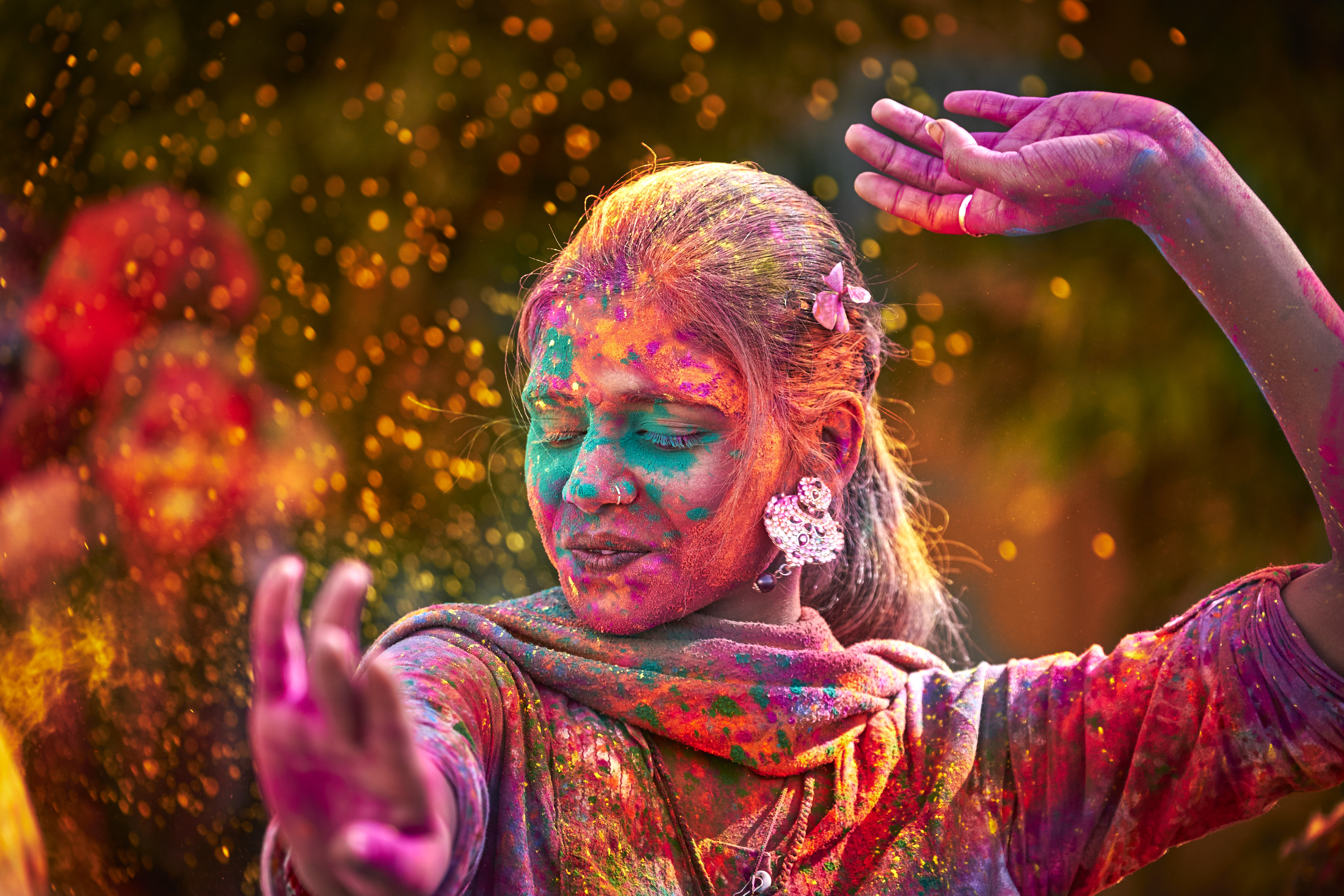 Woman With Colored Face Dancing During Holi festival in India
