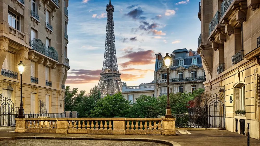 Eiffel Tower at dusk with Haussmann Apartment Buildings in the foreground in Paris, France