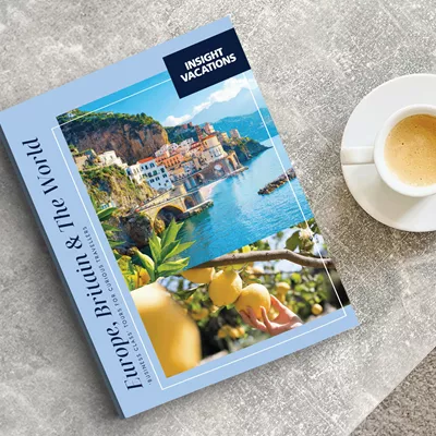 Insight Vacations brochure on table next to a cup of coffee