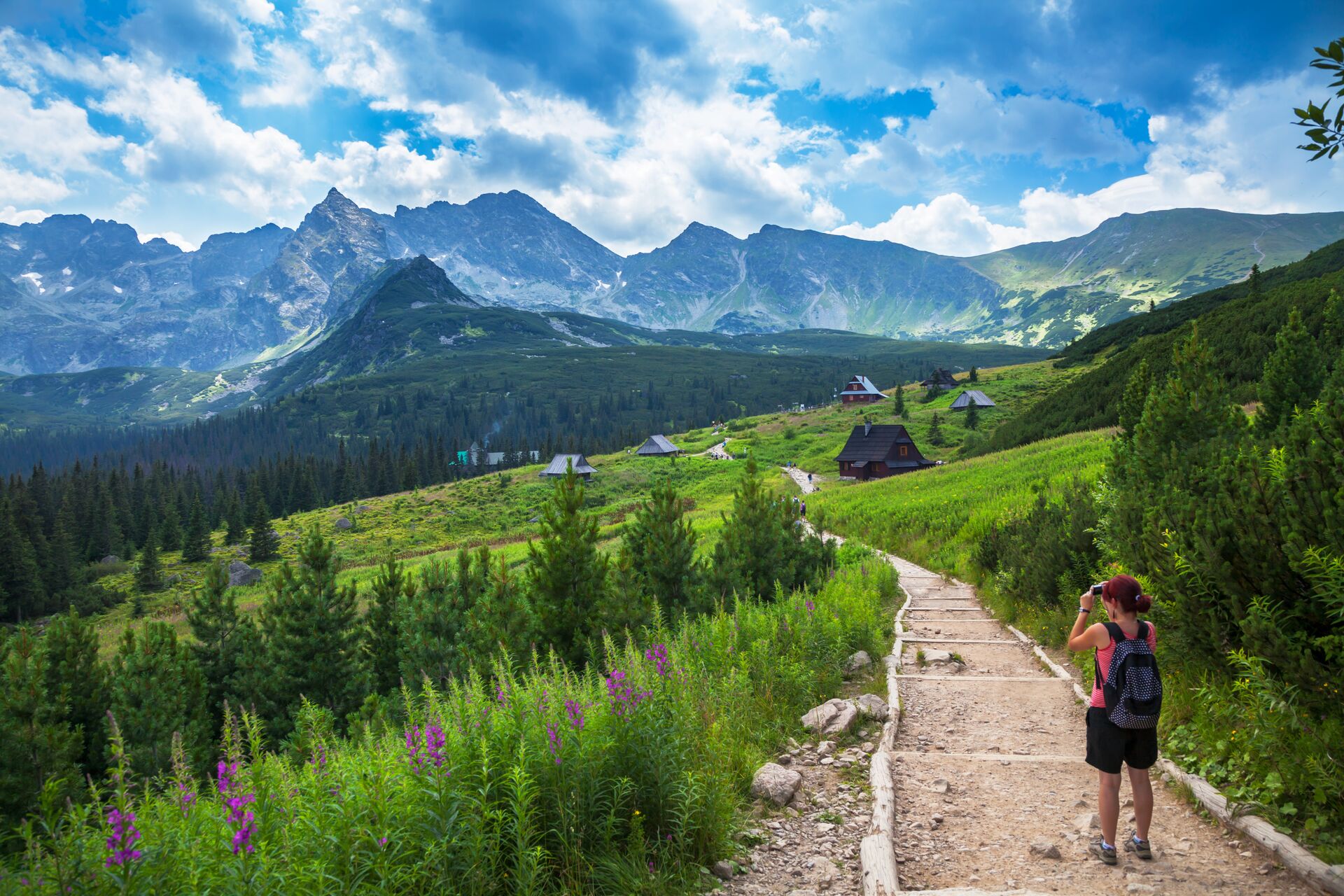 Female tourist taking picture in mountains in Poland, Eastern Europe