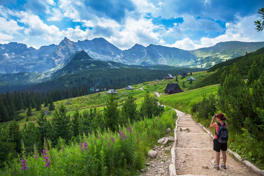 Female tourist taking picture in mountains in Poland, Eastern Europe