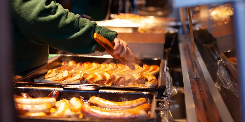 Sausages being fried at a Christmas Market stall in Dresden, Germany