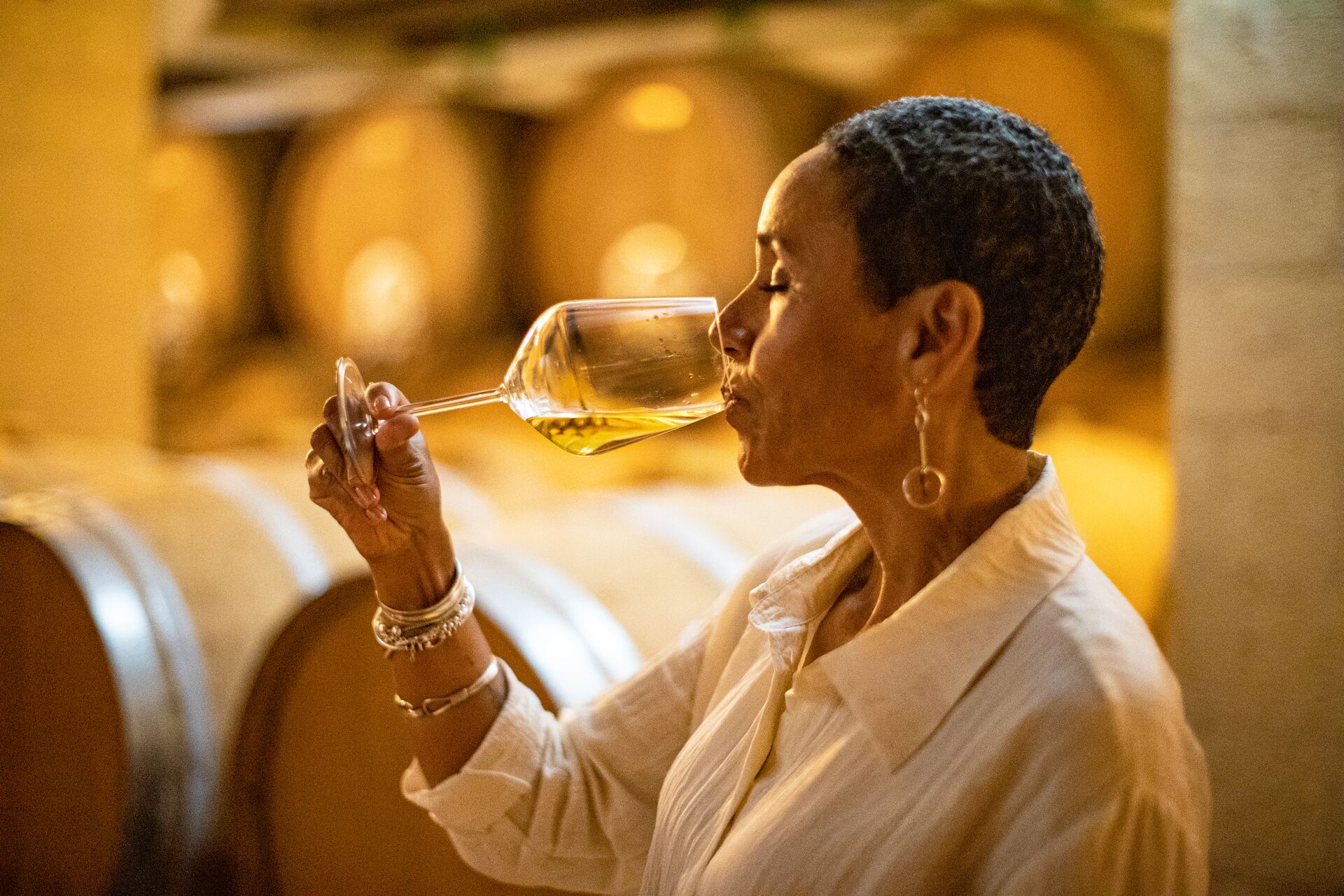 Lady drinking wine in cellar