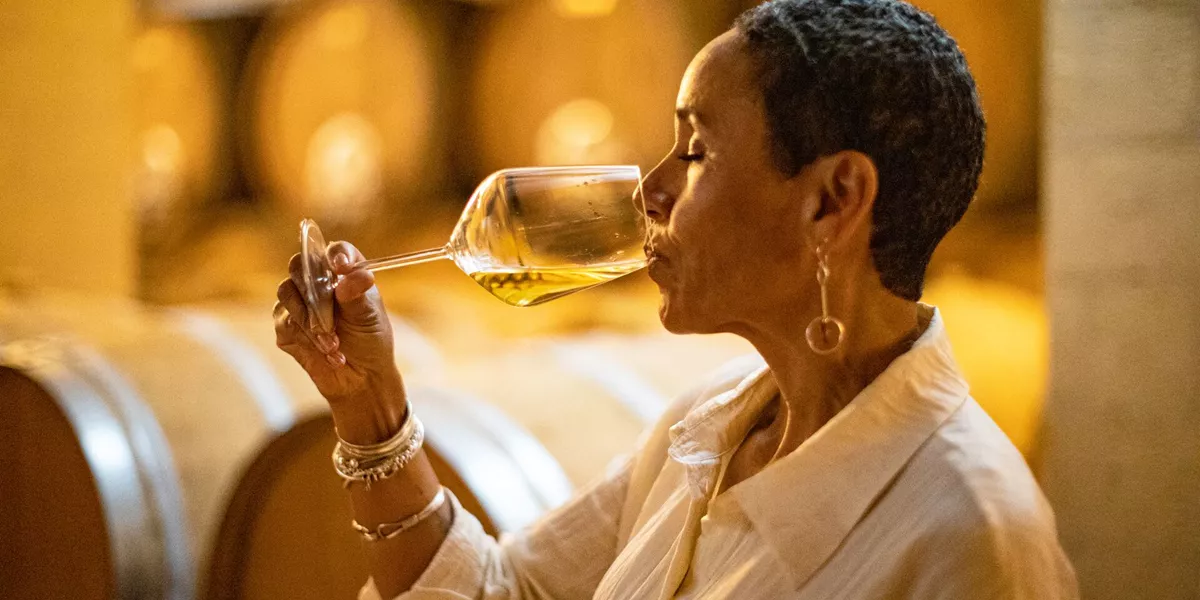 Lady drinking wine in cellar