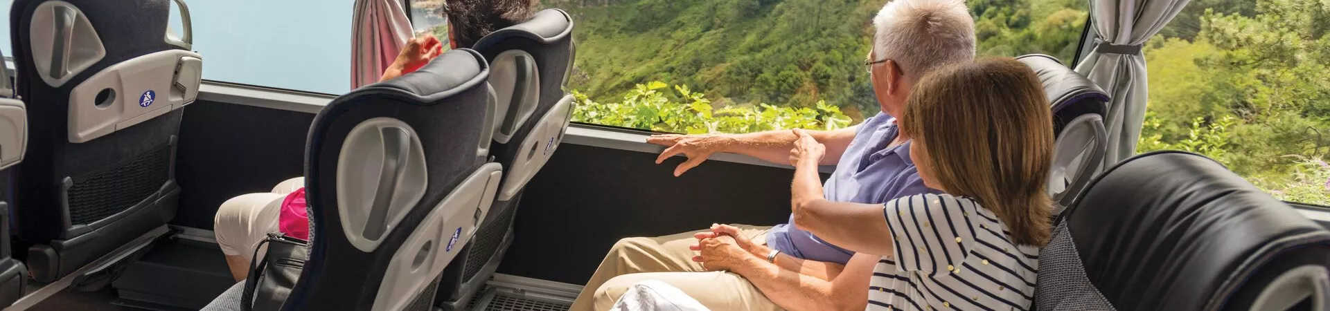 A couple sat on a coach with extra legroom and a great view of the scenery of Spain.