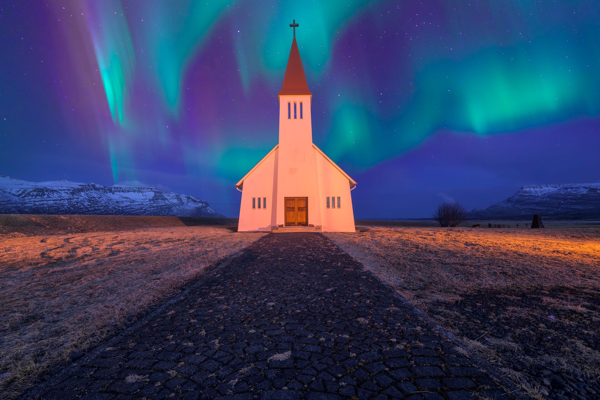 Northern Lights appearing over a Nordic church in Iceland